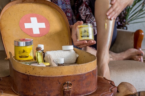 Divine Healer Salve taken out of first aid kit and applied to leg