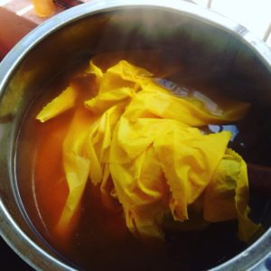 Dyeing Pot with turmeric dyed fabric inside