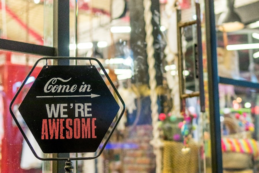 image of a store front with a welcoming sign saying "Come in, We're Awesome!"